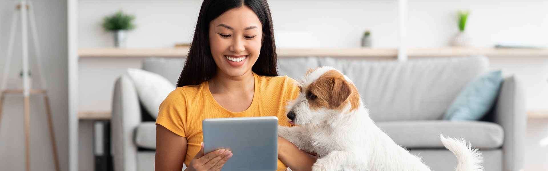 A woman with her dog and a tablet